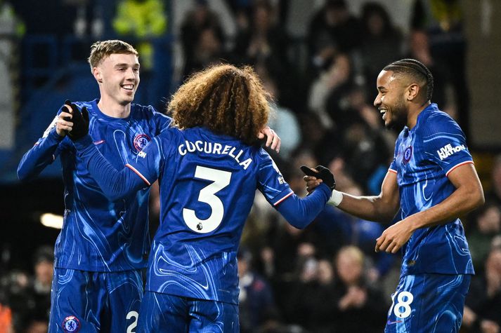 Chelsea's Spanish defender #03 Marc Cucurella (C) celebrates after scoring his team fourth goal with Chelsea's English midfielder #20 Cole Palmer (L) and Chelsea's French striker #18 Christopher Nkunku (R) during the English Premier League football match between Chelsea and Southampton at Stamford Bridge in London on February 25, 2025. (Photo by JUSTIN TALLIS / AFP) / RESTRICTED TO EDITORIAL USE. No use with unauthorized audio, video, data, fixture lists, club/league logos or 'live' services. Online in-match use limited to 120 images. An additional 40 images may be used in extra time. No video emulation. Social media in-match use limited to 120 images. An additional 40 images may be used in extra time. No use in betting publications, games or single club/league/player publications. / 