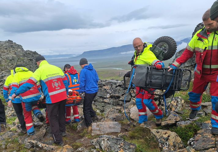 Ferðamaðurinn þurfti flutning í sjúkrabörum niður af klettaborginni.