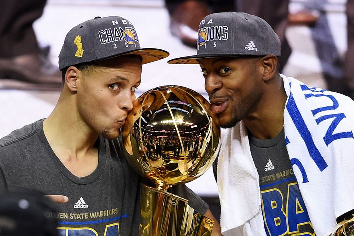 Andre Iguodala og Stephen Curry kyssa hér bikarinn.