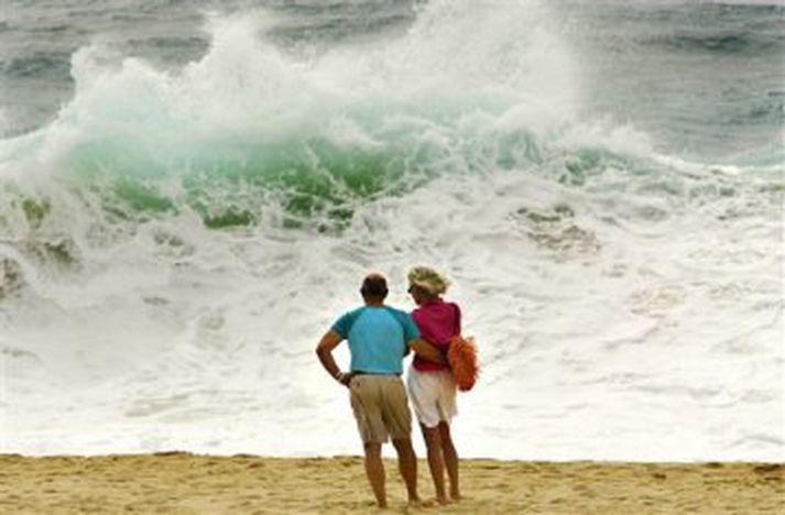 Fólk í Los Cabos í Mexíkó fylgist með öldunum aukast.