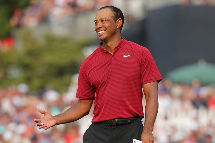 Tiger Woods hafði ástæðu til að brosa í gær.