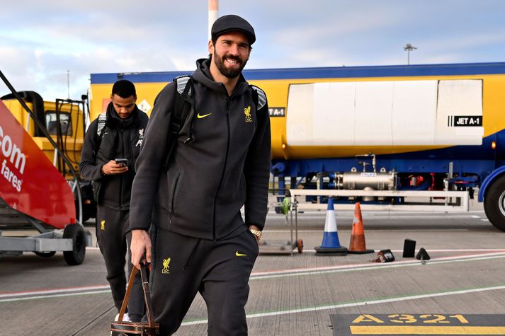 Alisson Becker sést hér ganga um borð í flugvélina sem fór með Liverpool liðið til Spánar.