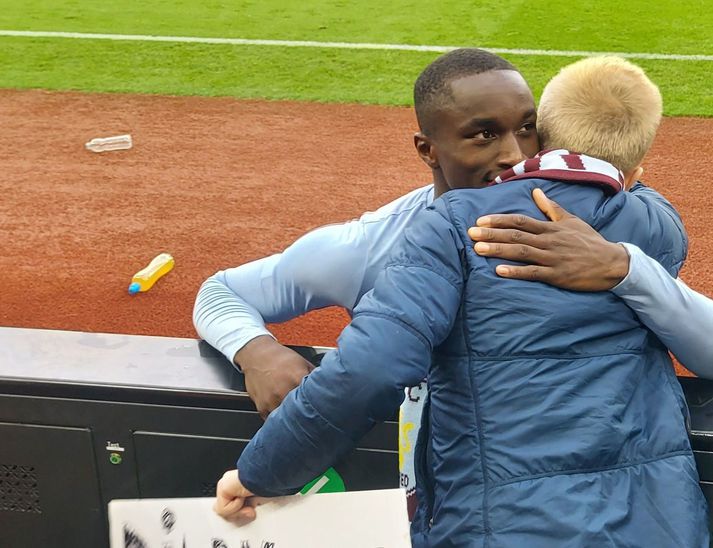 Moussa Diaby faðmar Skarphéðin Orra Albertsson, ungan íslenskan stuðningsmann Aston Villa.