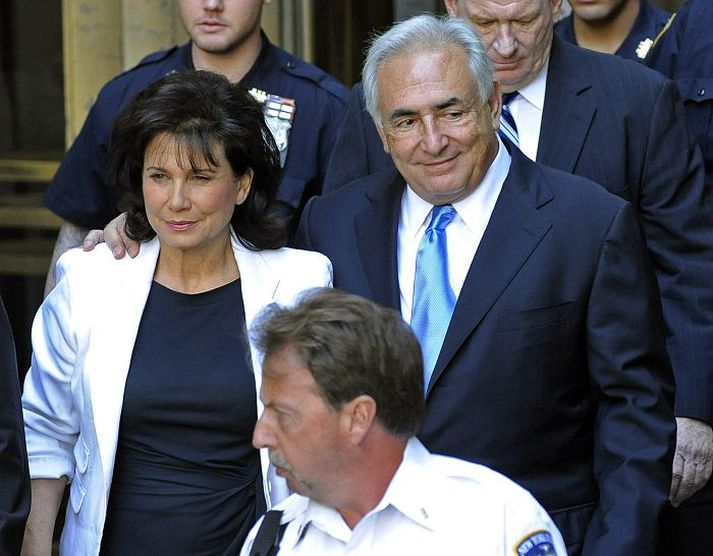 Dominique Strauss-Kahn var brosmildur þegar hann yfirgaf dómhúsið í New York ásamt eiginkonu sinni, Anne Sinclair.